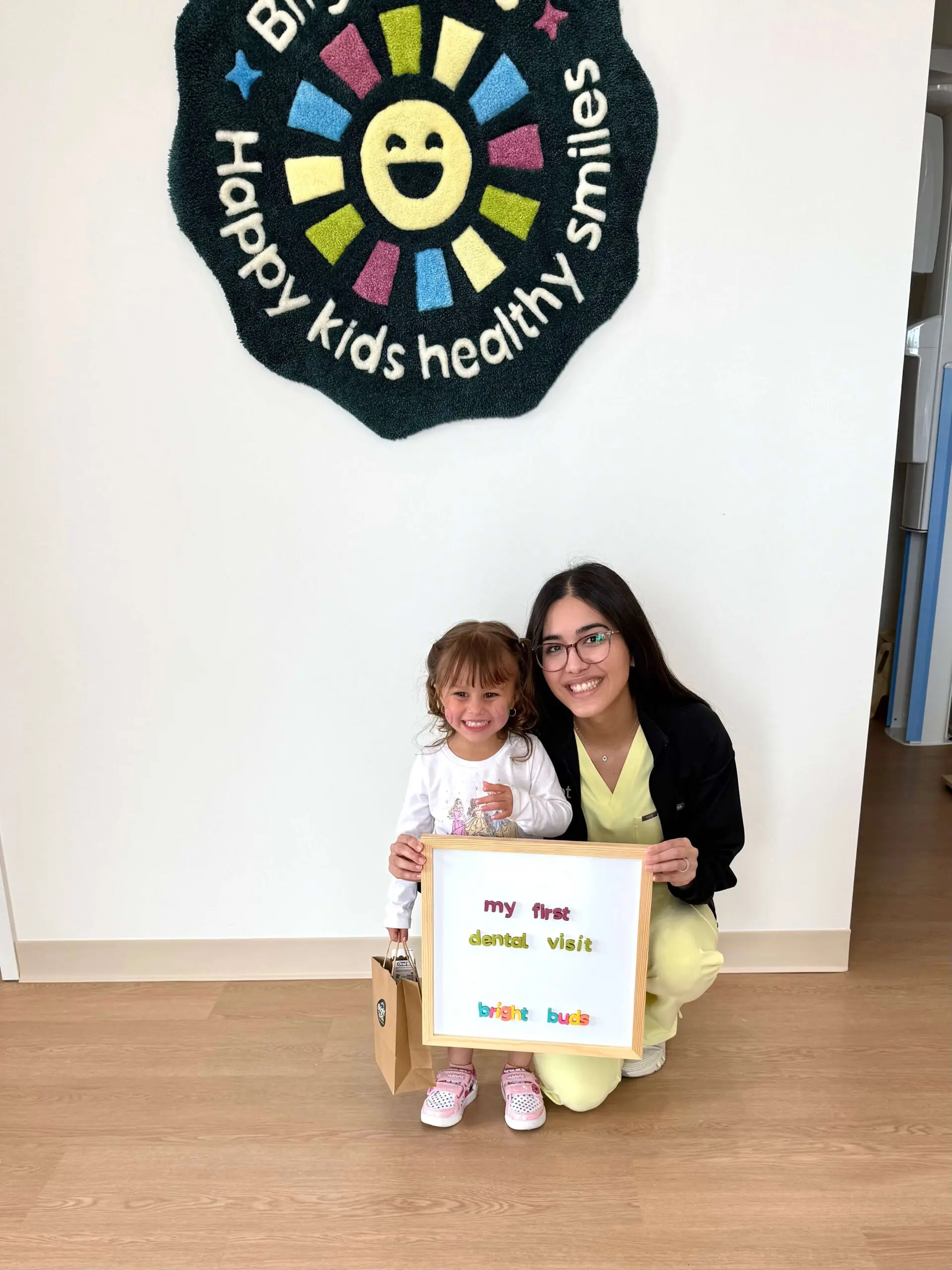 Dr. Peiravani and a smiling child at Bright Buds Dental