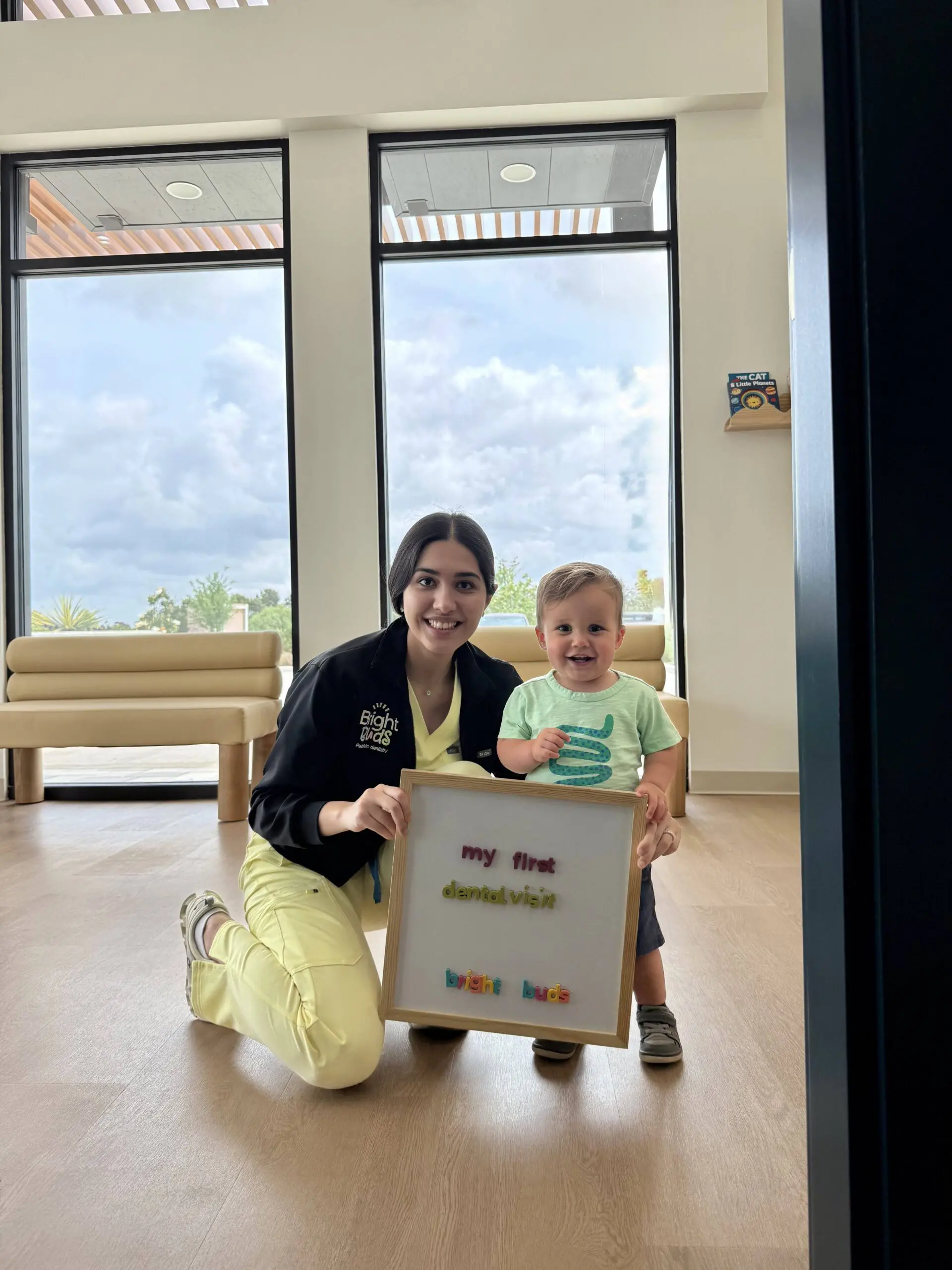 Dr. Peiravani and a smiling child at Bright Buds Dental