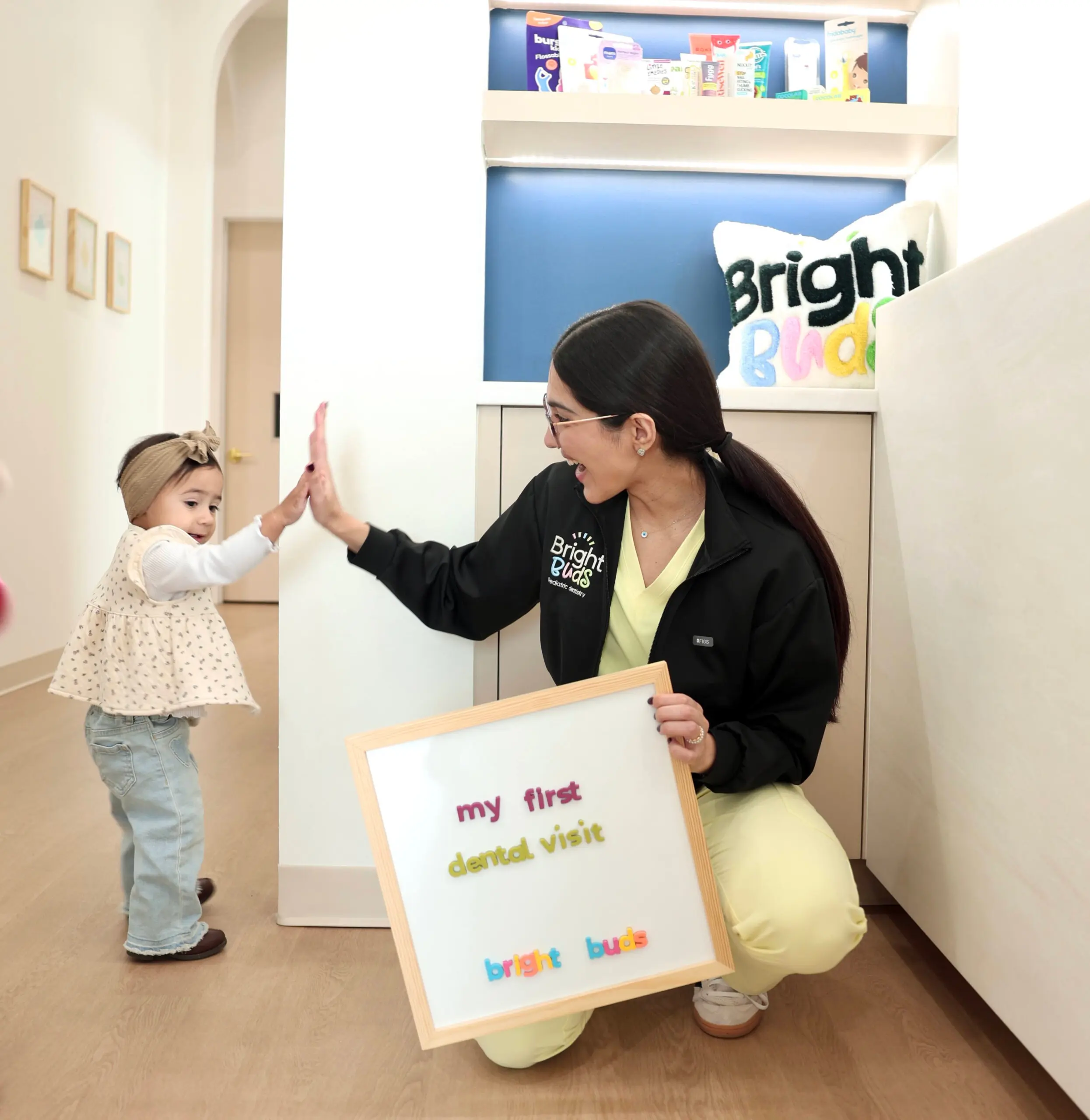 Child high fiving Dr. Peiravani at Bright Buds Pediatric Dentistry in Fulshear, TX